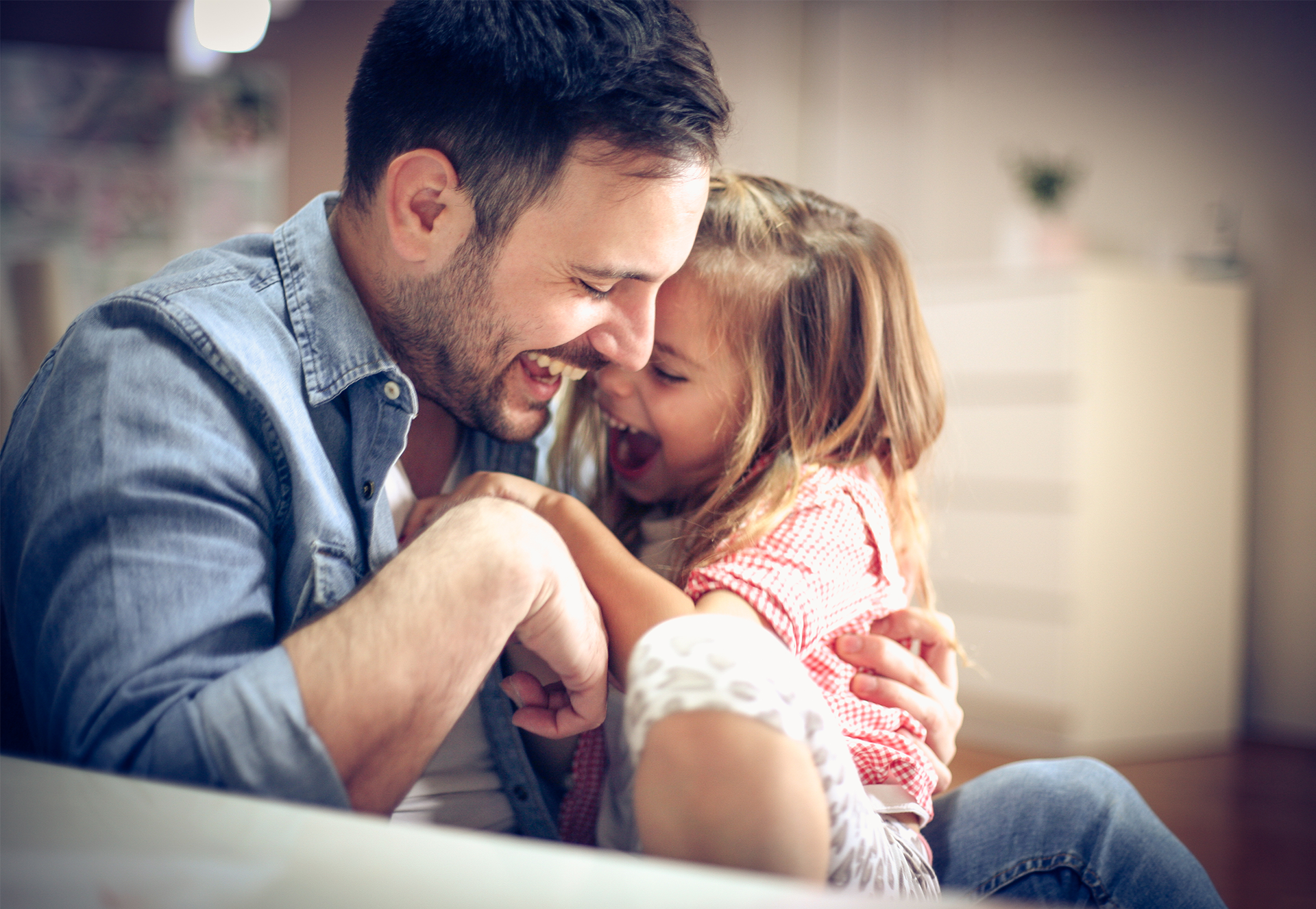 Father and daughter playing together at home.